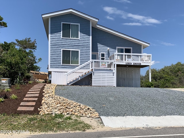 view of front facade with a wooden deck and stairway