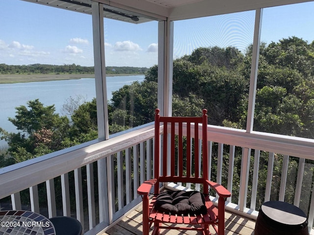 sunroom / solarium with a water view