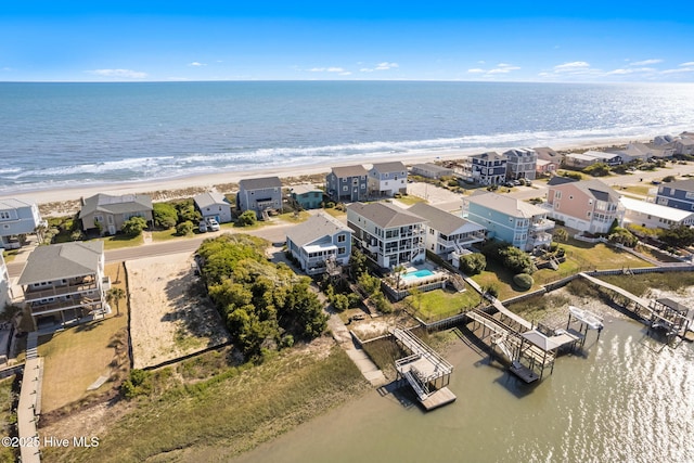 birds eye view of property featuring a beach view and a water view
