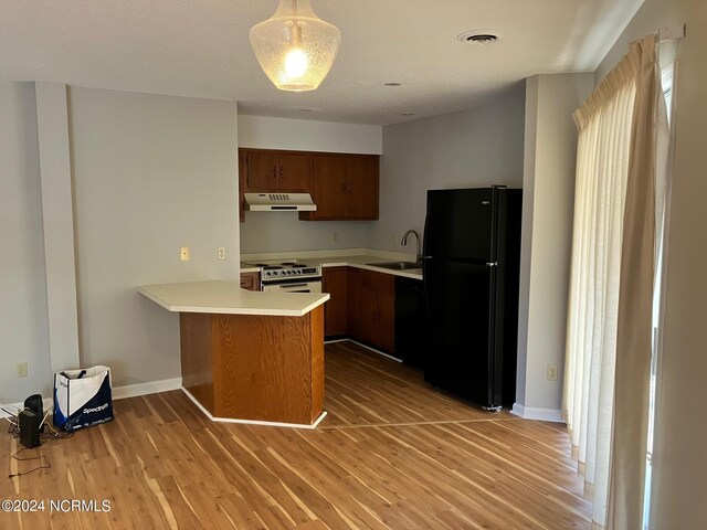 spare room featuring ceiling fan, wood-type flooring, and a textured ceiling