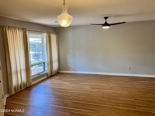 unfurnished room with a textured ceiling, ceiling fan, and wood-type flooring