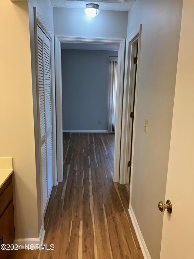 bathroom with hardwood / wood-style floors and dual vanity