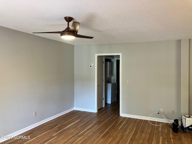 unfurnished room featuring a textured ceiling, a ceiling fan, baseboards, and dark wood-style flooring