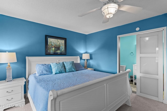 bedroom with ceiling fan, carpet floors, a textured ceiling, and baseboards