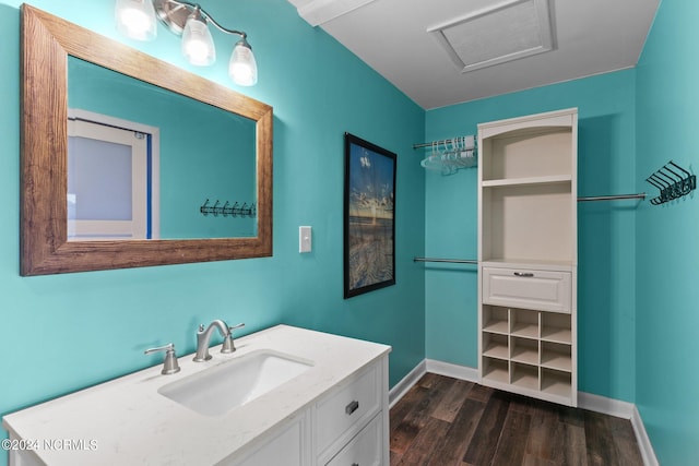 bathroom featuring vanity, baseboards, and wood finished floors