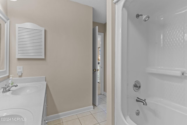 bathroom featuring double vanity, baseboards, tile patterned flooring, shower / washtub combination, and a sink