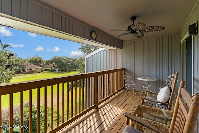 wooden deck featuring a yard and ceiling fan