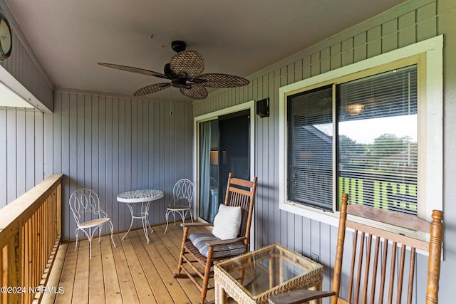 wooden deck with a ceiling fan