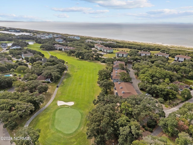 drone / aerial view with view of golf course and a water view