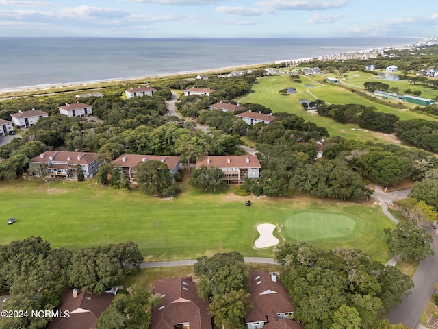 drone / aerial view featuring golf course view and a water view