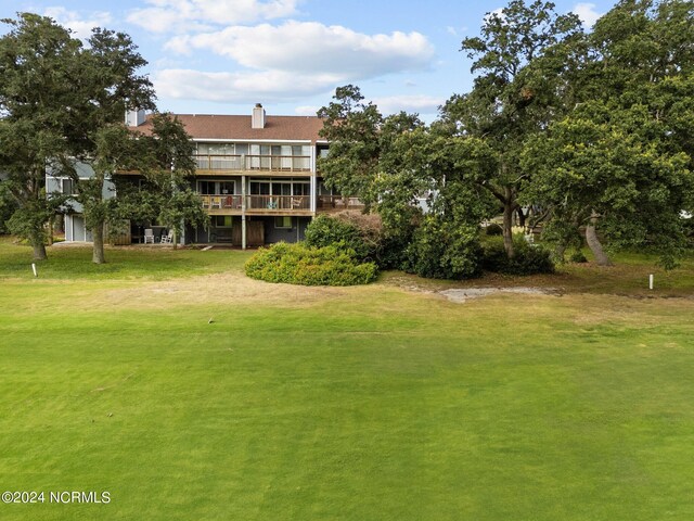 view of community with a deck and a yard