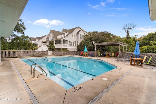 pool featuring a patio area and fence