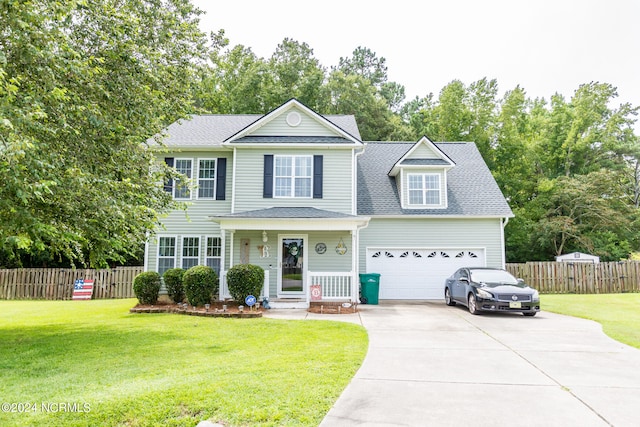 view of front property featuring a garage and a front lawn