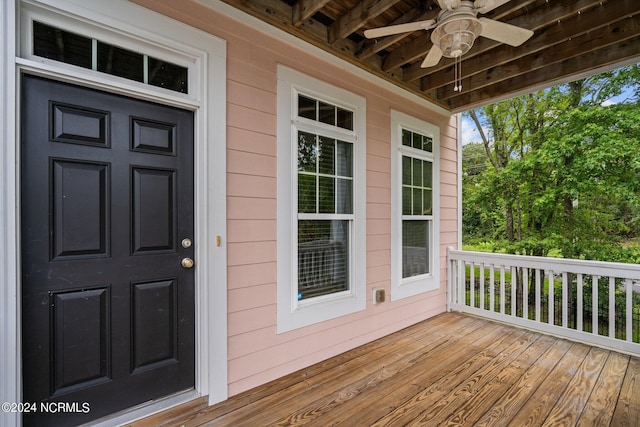 view of exterior entry with ceiling fan