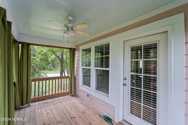 wooden deck featuring ceiling fan