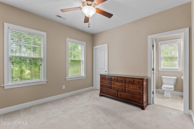 bedroom featuring ensuite bath, carpet flooring, and baseboards