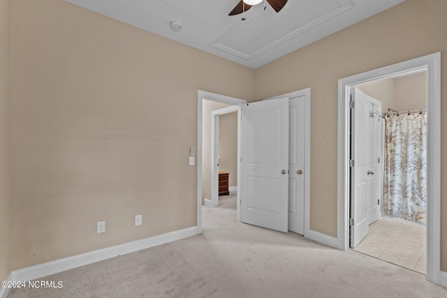 unfurnished bedroom featuring ensuite bath, attic access, baseboards, and carpet floors