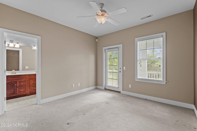 unfurnished bedroom with visible vents, light carpet, baseboards, and access to exterior