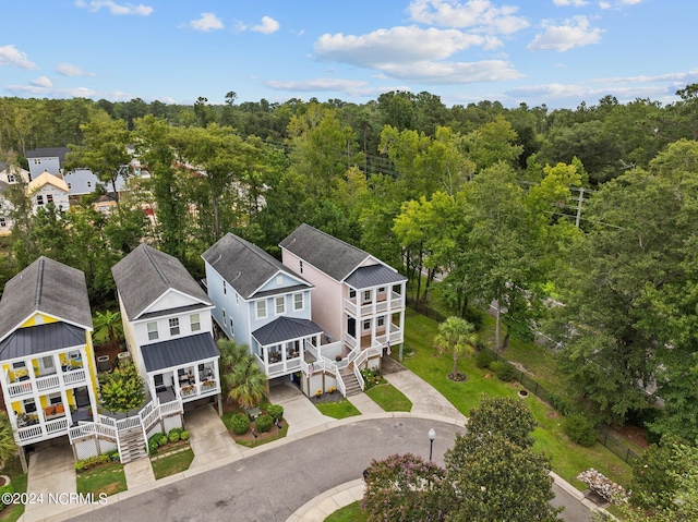 drone / aerial view with a residential view and a wooded view