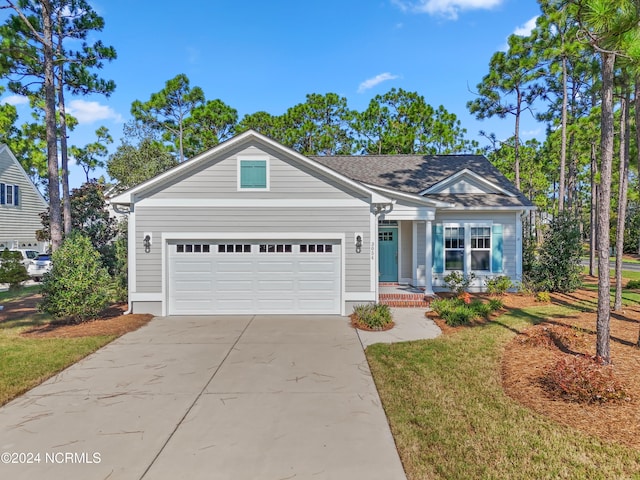 view of front facade featuring a front yard and a garage