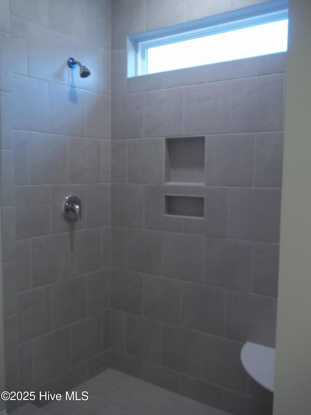 bathroom with a tile shower