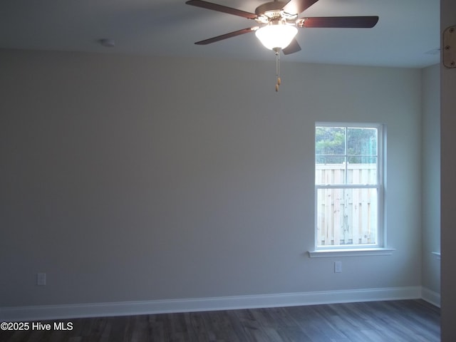 unfurnished room with ceiling fan, baseboards, and wood finished floors