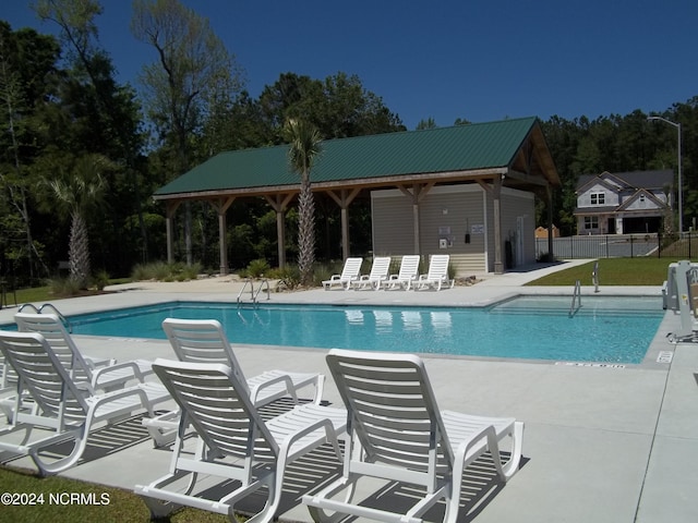pool featuring a patio and fence