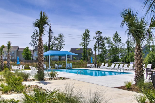 pool featuring a patio area and fence