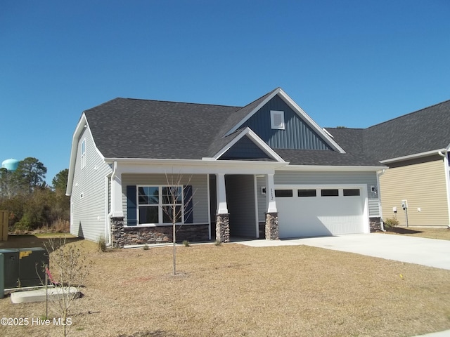 craftsman house featuring stone siding, roof with shingles, board and batten siding, concrete driveway, and an attached garage