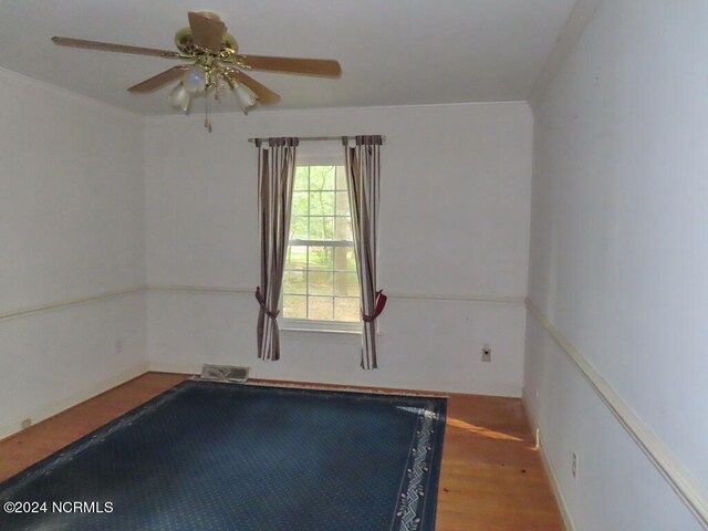 spare room with a ceiling fan and wood finished floors