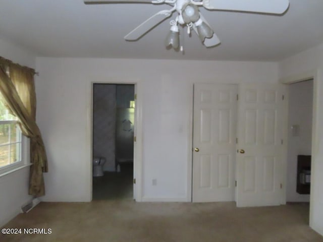 unfurnished bedroom with ceiling fan and carpet floors