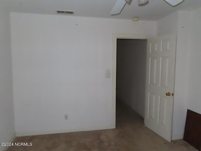 unfurnished room featuring baseboards, visible vents, and a ceiling fan