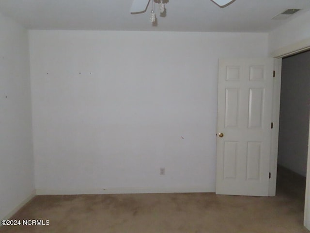 spare room featuring a ceiling fan and visible vents