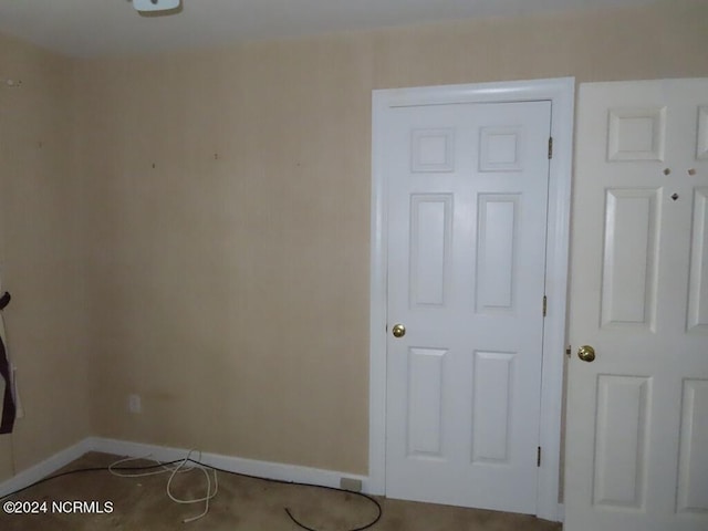 spare room with baseboards