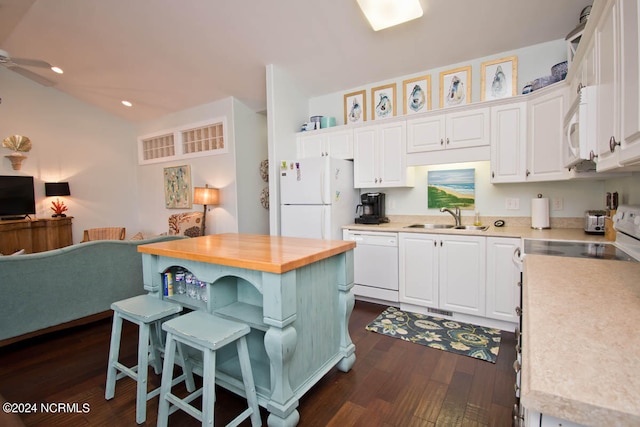 kitchen featuring sink, white cabinets, white appliances, and dark wood-type flooring