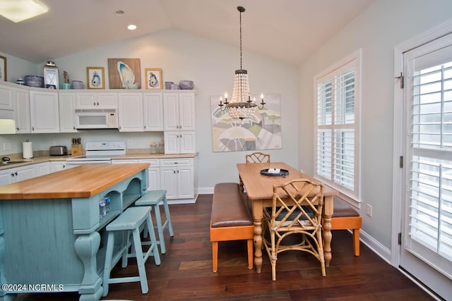 kitchen with butcher block counters, white appliances, and white cabinets