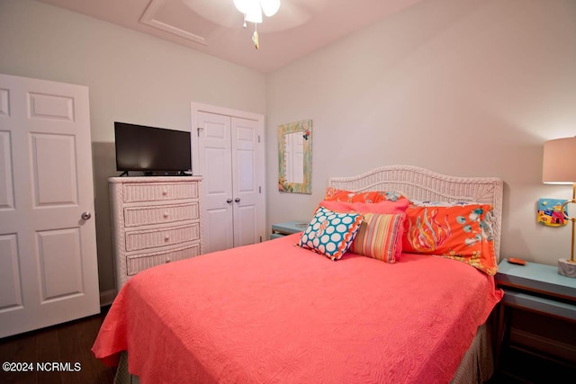 bedroom with ceiling fan, dark wood-type flooring, a closet, and attic access