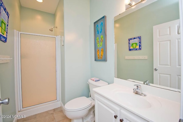 bathroom featuring toilet, a stall shower, tile patterned floors, and vanity