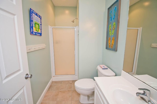 full bath featuring toilet, a shower stall, baseboards, and tile patterned floors