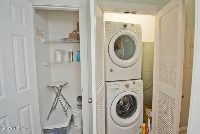 laundry room with stacked washer / drying machine