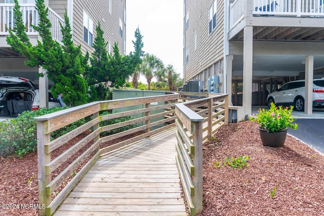 wooden deck featuring a carport