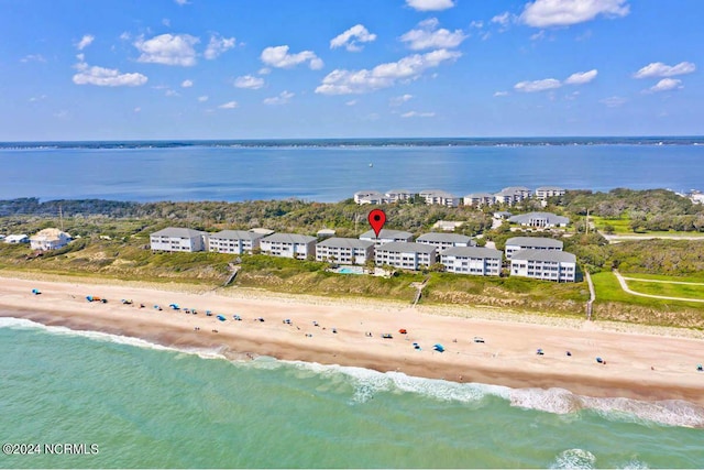 bird's eye view featuring a water view and a beach view