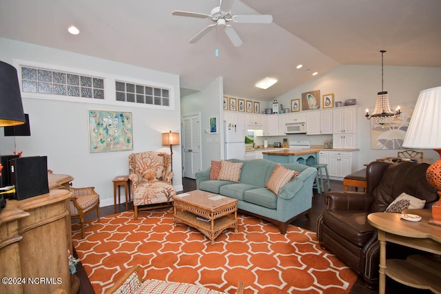 living room featuring high vaulted ceiling, ceiling fan with notable chandelier, and hardwood / wood-style flooring