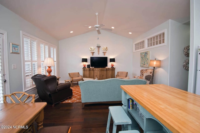 dining room with ceiling fan, dark wood-type flooring, and vaulted ceiling