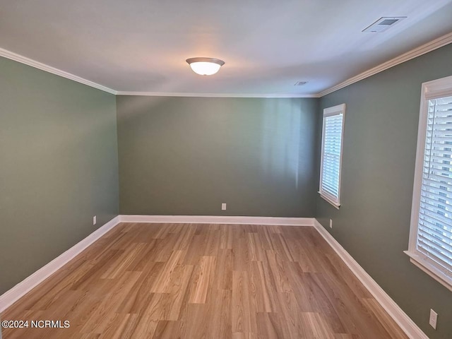 unfurnished room with crown molding and light hardwood / wood-style flooring