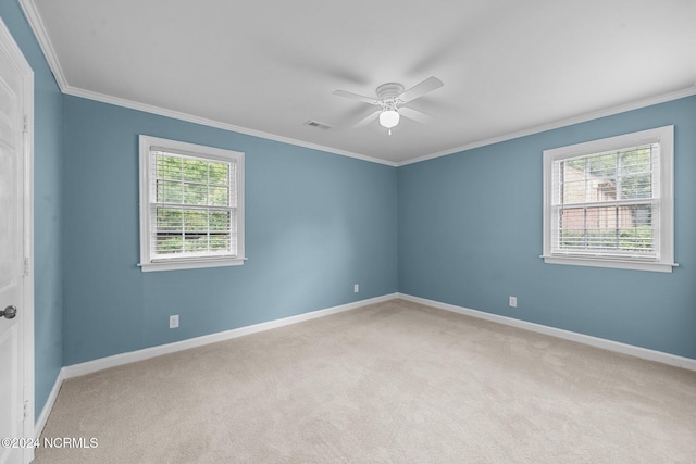 carpeted empty room with ornamental molding and ceiling fan