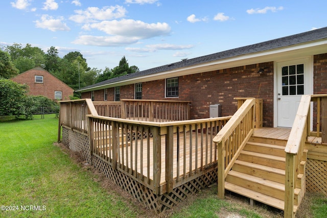 wooden terrace featuring a yard