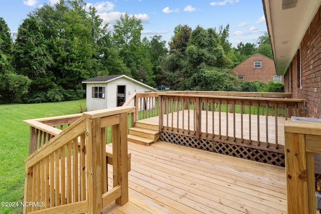 wooden deck featuring an outdoor structure and a lawn