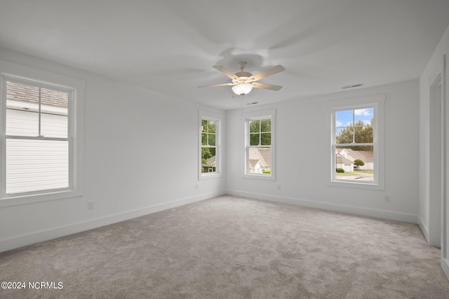 unfurnished room with ceiling fan and light carpet