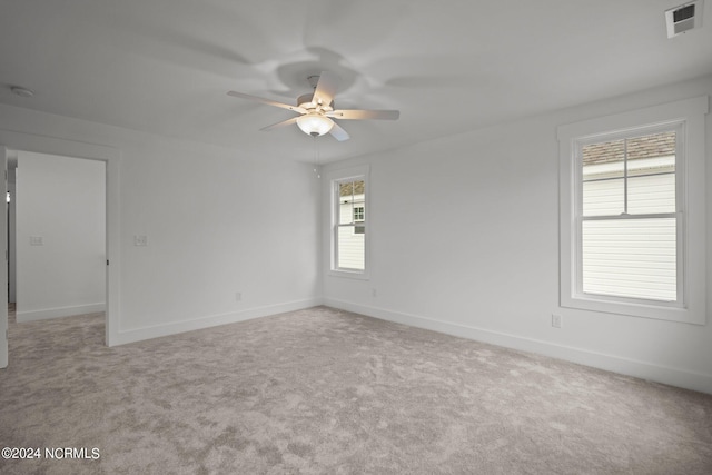 unfurnished room featuring light carpet and ceiling fan